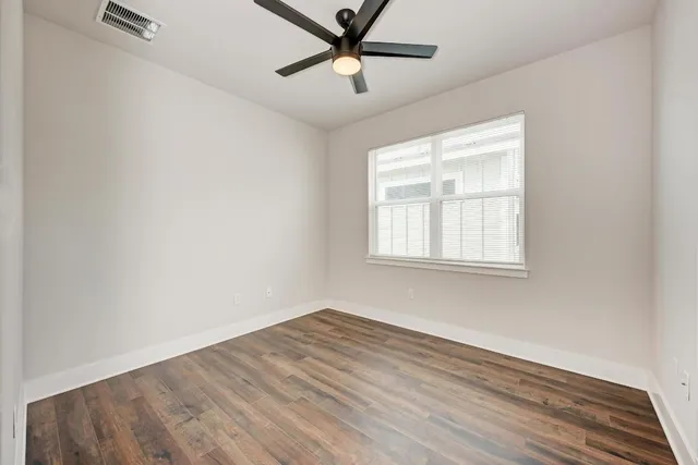 a bathroom with a granite countertop sink a toilet a mirror and shower