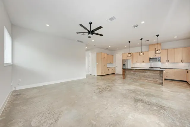 a view of a kitchen with a sink and cabinets