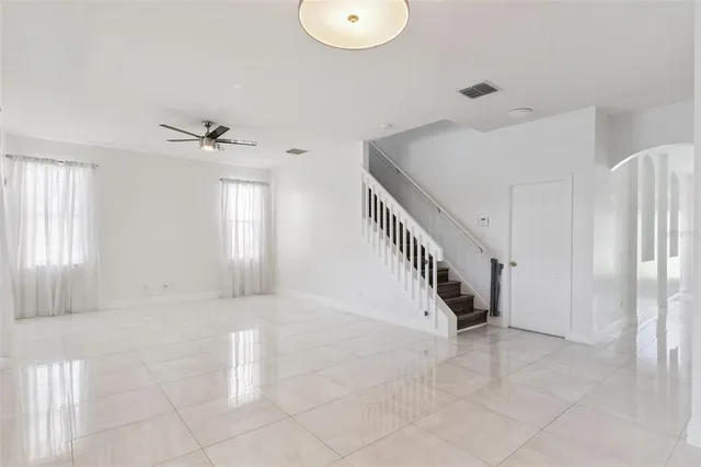 a view of staircase with white walls and windows