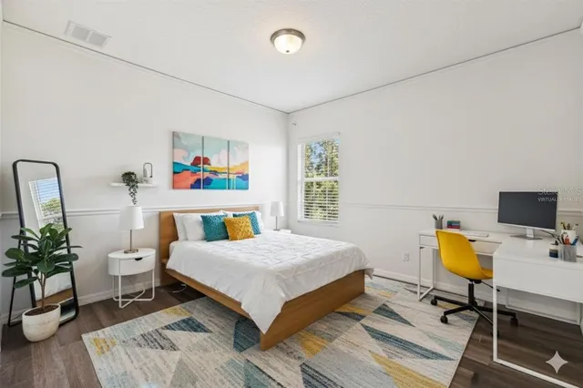 a bedroom with a bed and a workspace