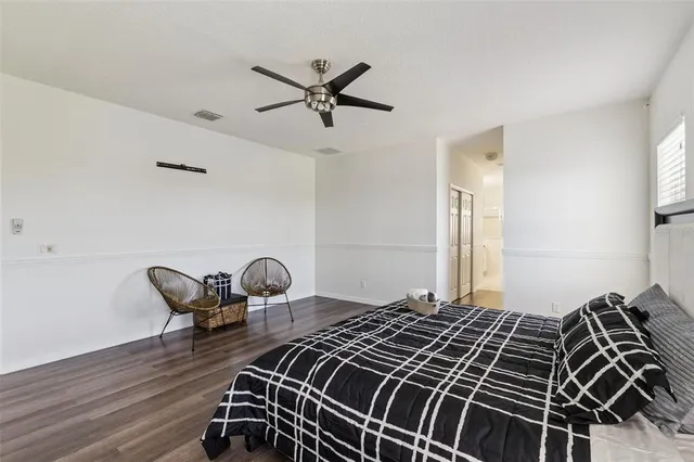 a bedroom with bed and chair