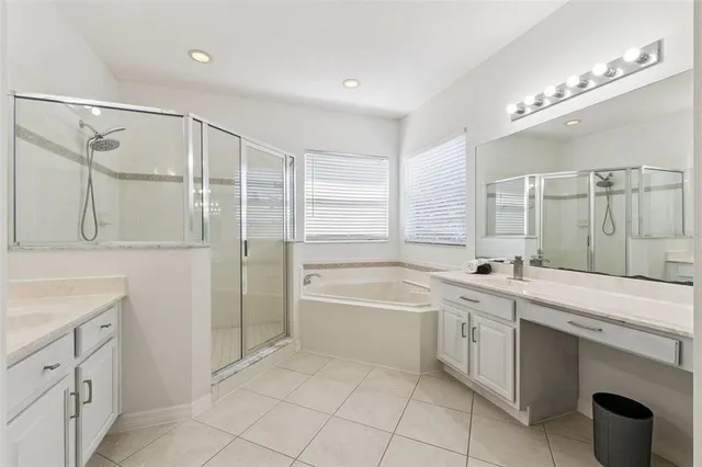 a spacious bathroom with a shower sink vanity and mirror