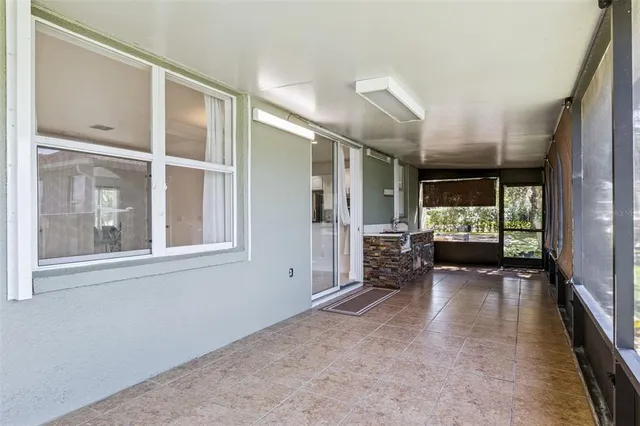 a view of empty room with large windows