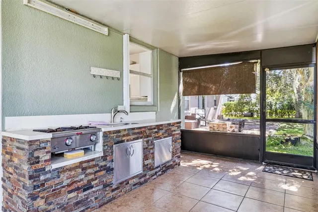 a room with stainless steel appliances granite countertop a sink and cabinets