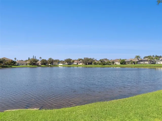 a view of a lake with houses in the back