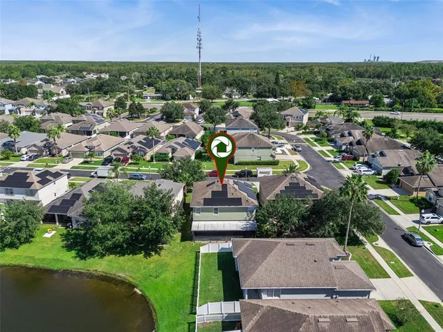 an aerial view of residential houses with outdoor space and street view
