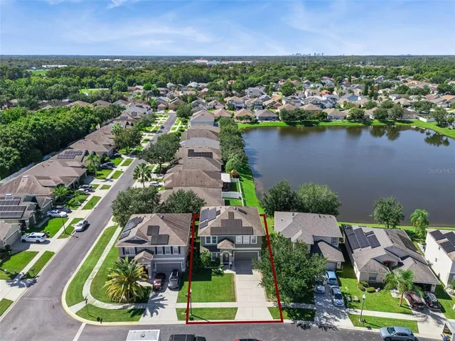 an aerial view of a house with a lake view