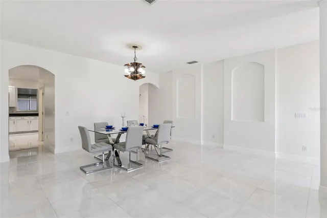 a view of a dining room with furniture and chandelier