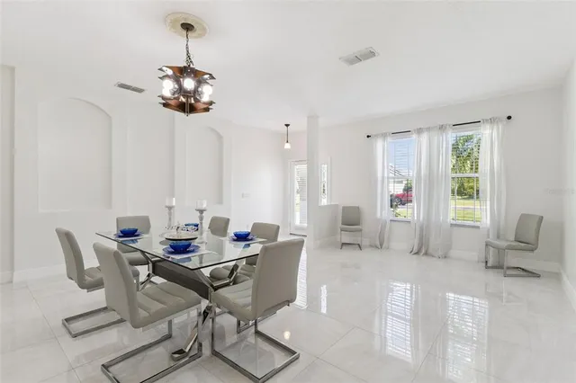 a view of a dining room with furniture and chandelier