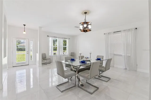 a view of a dining room with furniture and chandelier