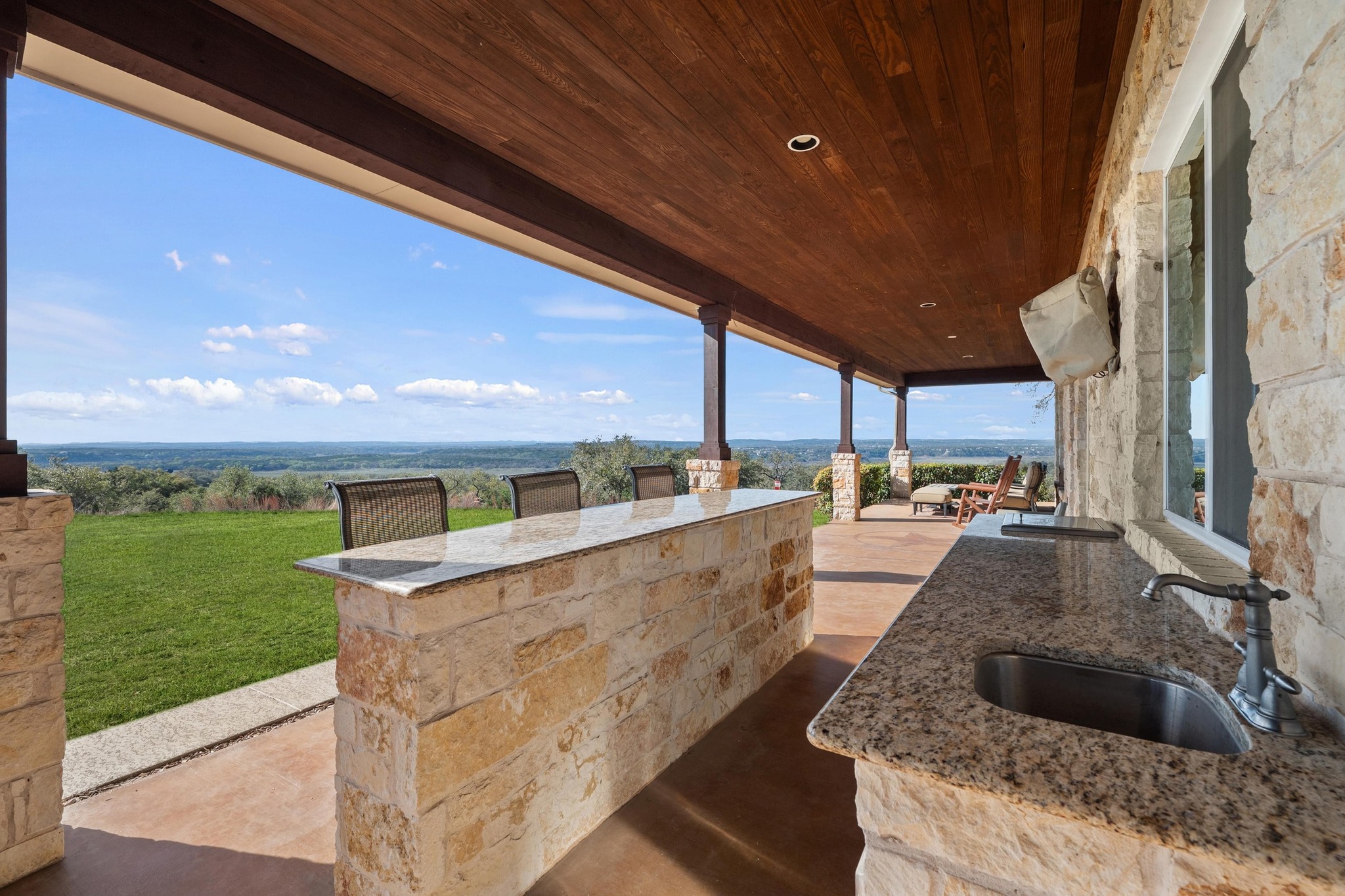 28701 Valley Road Marble Falls, TX 78654 - Photo 23 of 35 a view of a kitchen with a sink and outdoor seating