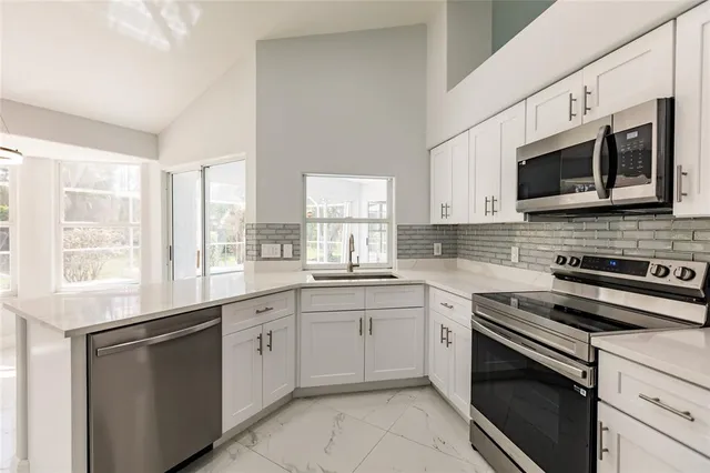 a kitchen with a sink window and cabinets