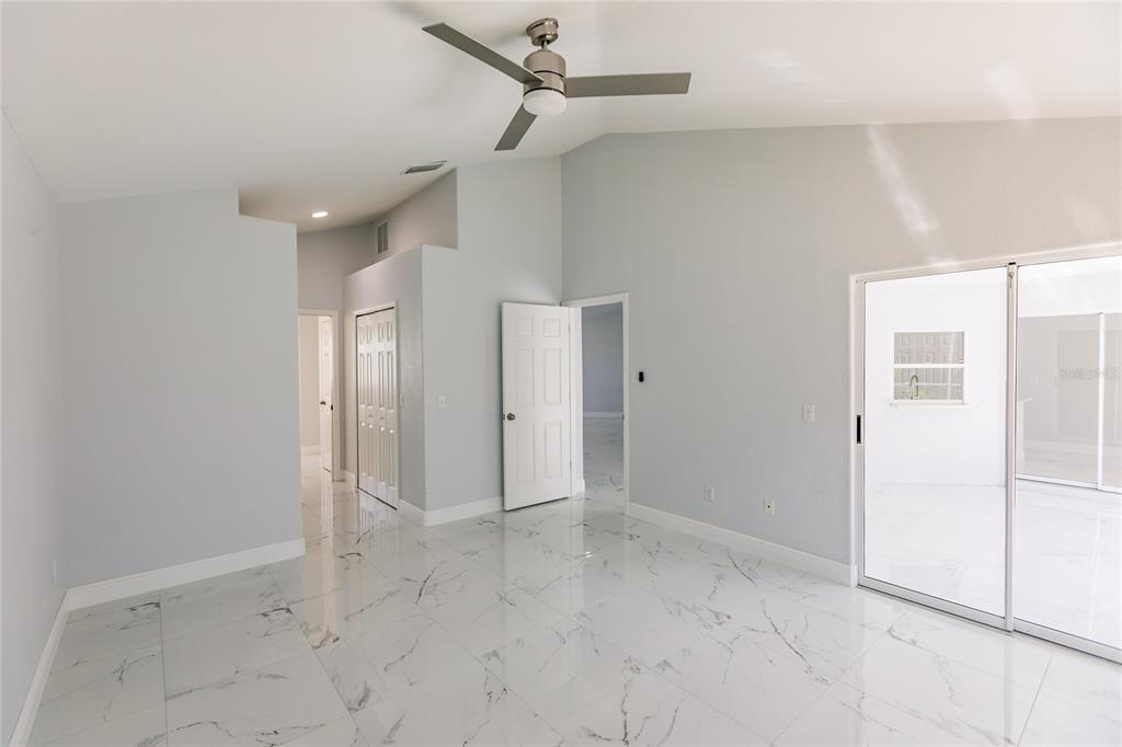 1304 Islamorada Boulevard Punta Gorda, FL 33955 - Photo 17 of 45 an empty room with chandelier fan and windows