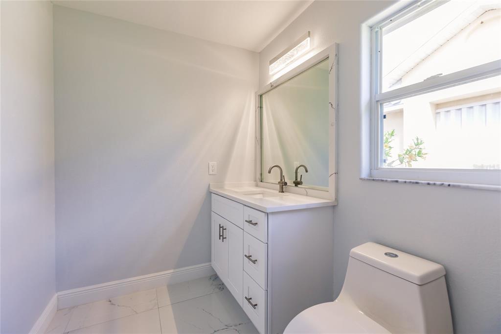 1304 Islamorada Boulevard Punta Gorda, FL 33955 - Photo 23 of 45 a spacious bathroom with a toilet sink and mirror