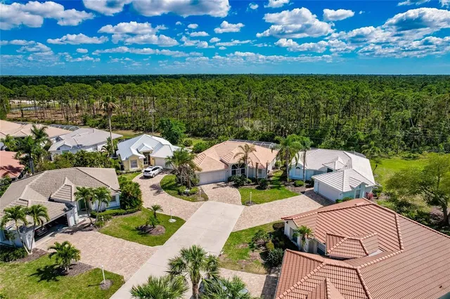 an aerial view of multiple houses with yard