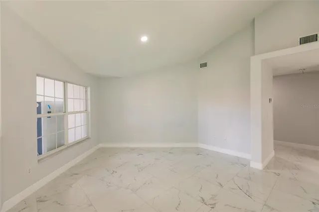 a kitchen with stainless steel appliances white cabinets a sink and a stove