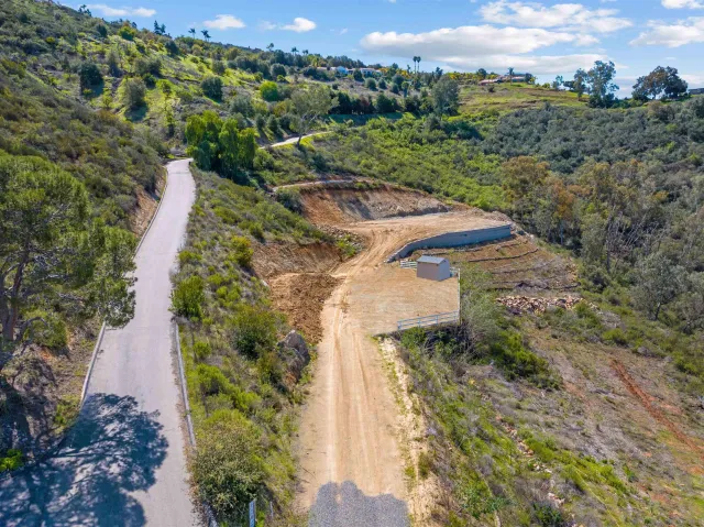 an aerial view of a house with a yard and mountain view