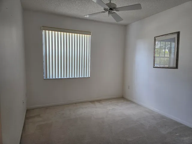 a kitchen with a refrigerator and a counter top space