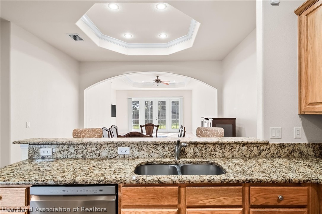 5224 Haw Branch Road Sebring, FL 33875 - Photo 5 of 40 a kitchen with granite countertop a sink and a wooden floors
