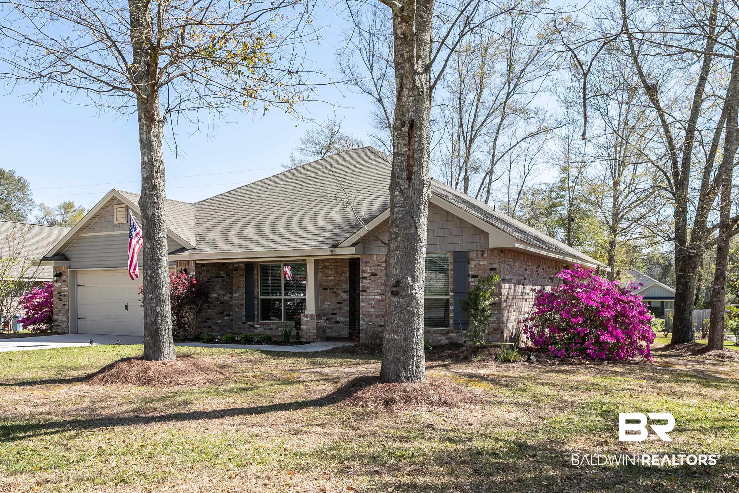 13154 Vincent Court Foley, AL 36535 - Photo 41 of 41 View of front of house featuring concrete driveway, a garage, a front lawn, brick siding, and a shingled roof