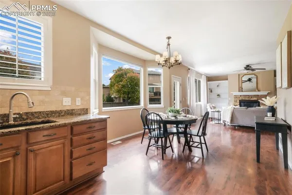 a view of a dining room with furniture window and wooden floor