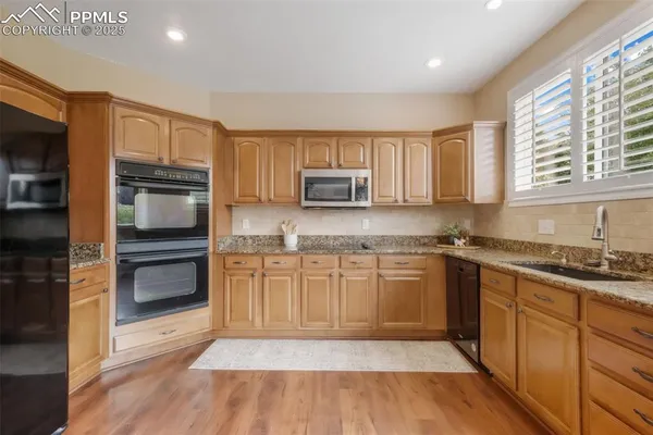a kitchen with granite countertop stainless steel appliances and cabinets