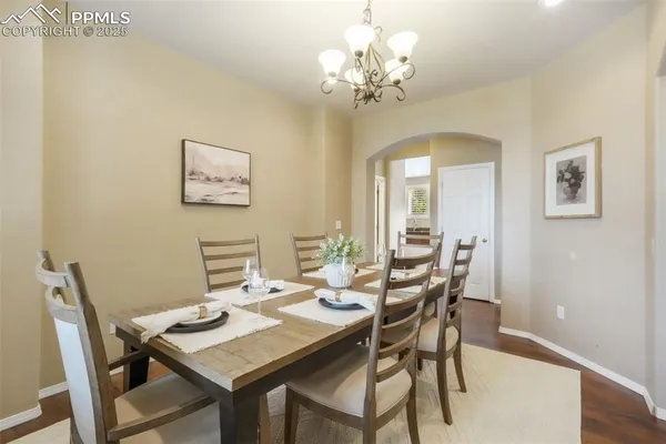 a view of a dining room with furniture and chandelier