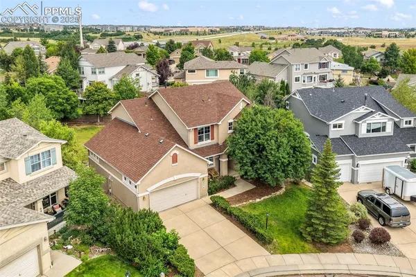 an aerial view of residential houses with outdoor space and city view