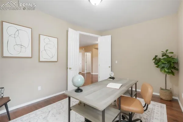a view of a workspace room with furniture and wooden floor