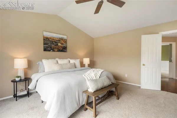 a spacious bedroom with a bed and furniture