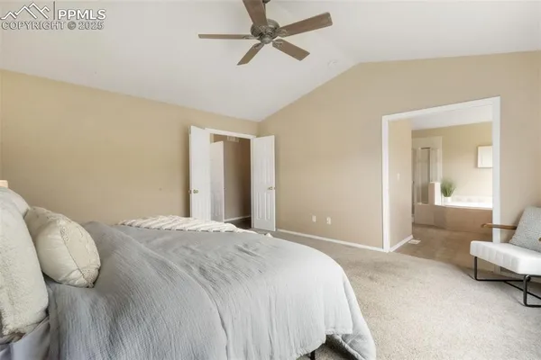 a spacious bedroom with a bed and a couch
