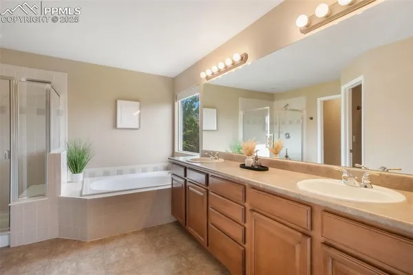 a bathroom with a tub sink and mirror