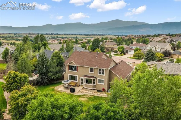 a aerial view of a house with pool and a lake view