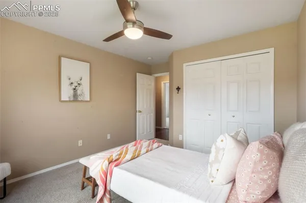a view of a big room with wooden floor and a ceiling fan