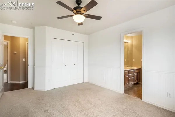 a view of an empty room with window and cabinet