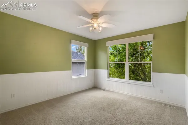 an empty room with white wall and garage