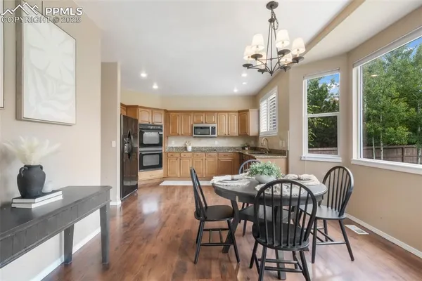 a view of a dining room with furniture window and wooden floor
