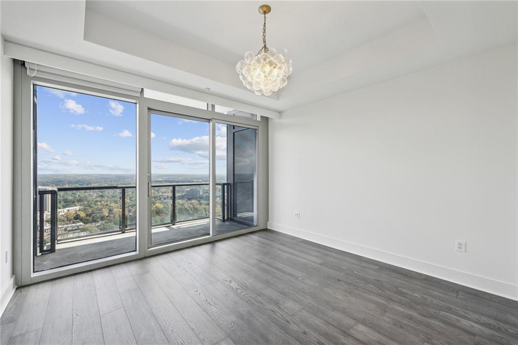 3630 Peachtree Road Northeast, Unit 3106 Atlanta, GA 30326 - Photo 15 of 41 a view of an empty room with wooden floor and a window