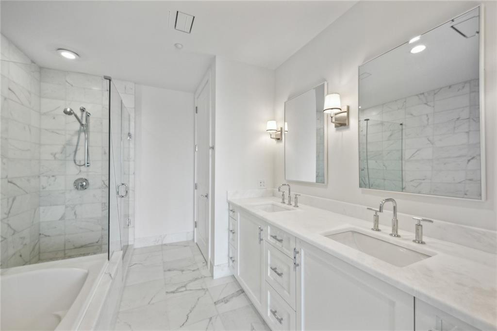 3630 Peachtree Road Northeast, Unit 3106 Atlanta, GA 30326 - Photo 17 of 41 a bathroom with a double vanity sink mirror double and shower