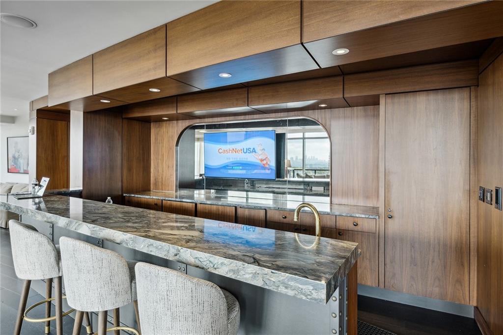 3630 Peachtree Road Northeast, Unit 3106 Atlanta, GA 30326 - Photo 27 of 41 a kitchen with a sink and a refrigerator
