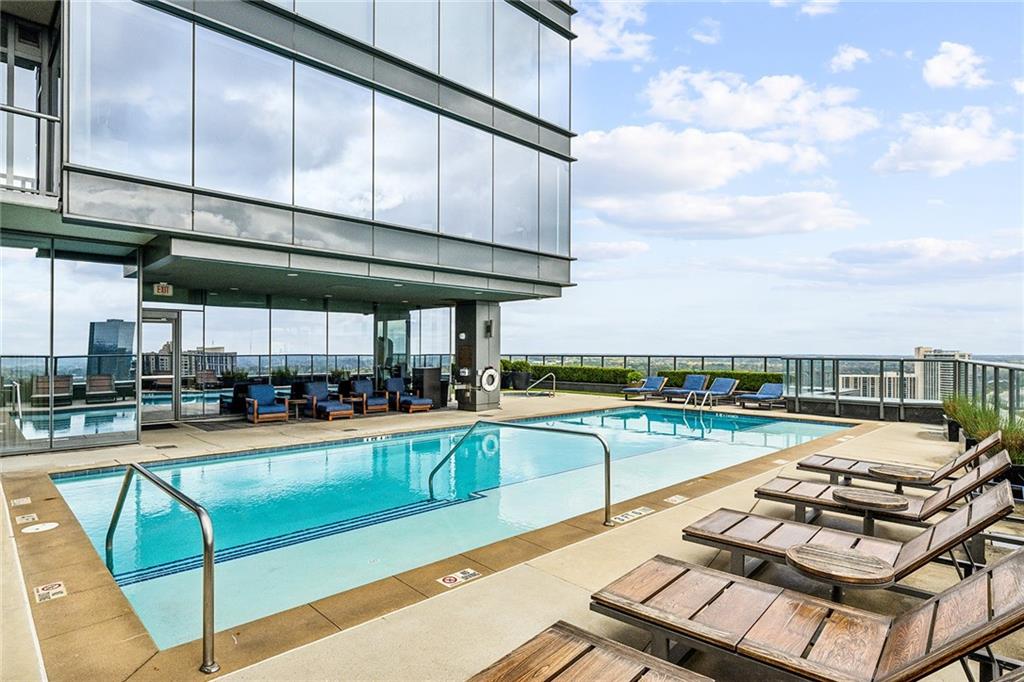 3630 Peachtree Road Northeast, Unit 3106 Atlanta, GA 30326 - Photo 29 of 41 a view of a swimming pool with a lounge chair