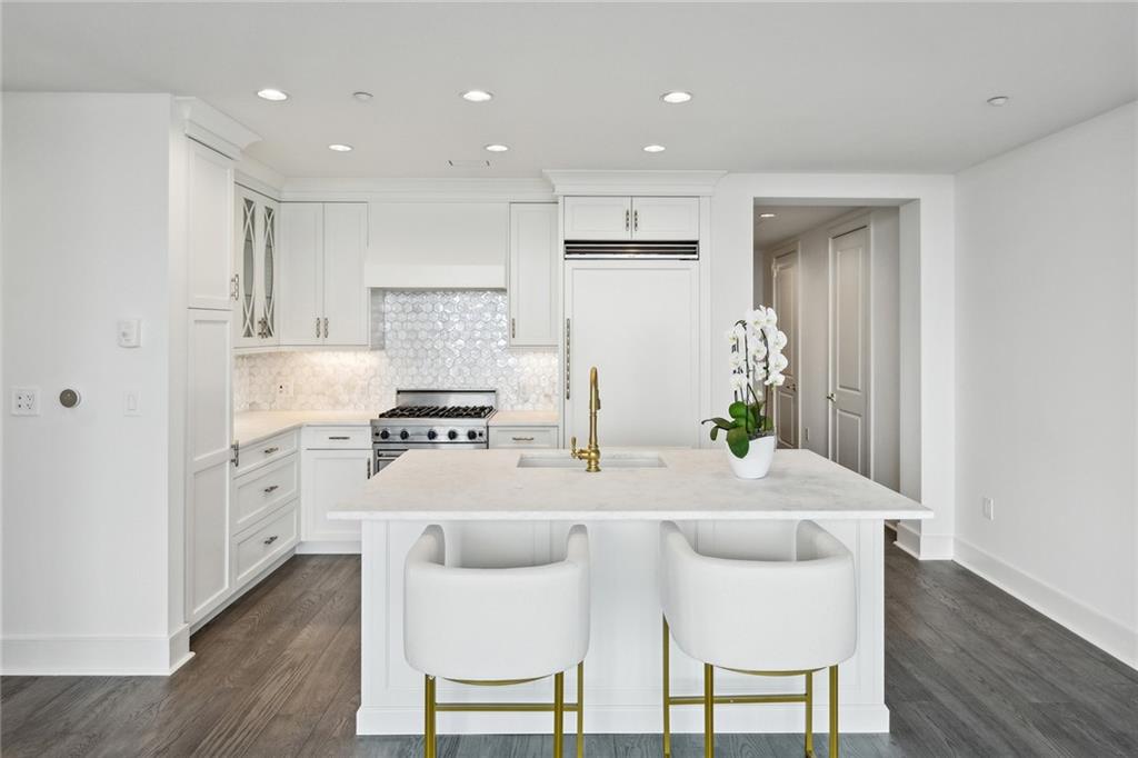 3630 Peachtree Road Northeast, Unit 3106 Atlanta, GA 30326 - Photo 4 of 41 a kitchen with white cabinets and stainless steel appliances