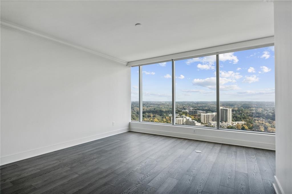 3630 Peachtree Road Northeast, Unit 3106 Atlanta, GA 30326 - Photo 9 of 41 wooden floor in an empty room with window
