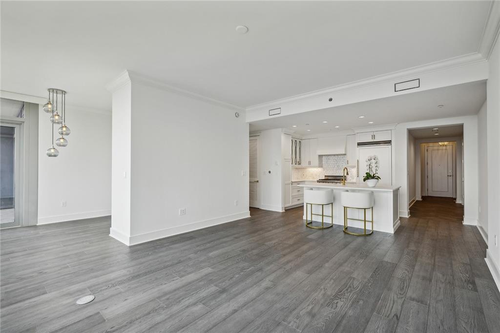 3630 Peachtree Road Northeast, Unit 3106 Atlanta, GA 30326 - Photo 10 of 41 a view of a dining hall with wooden floor and a sink