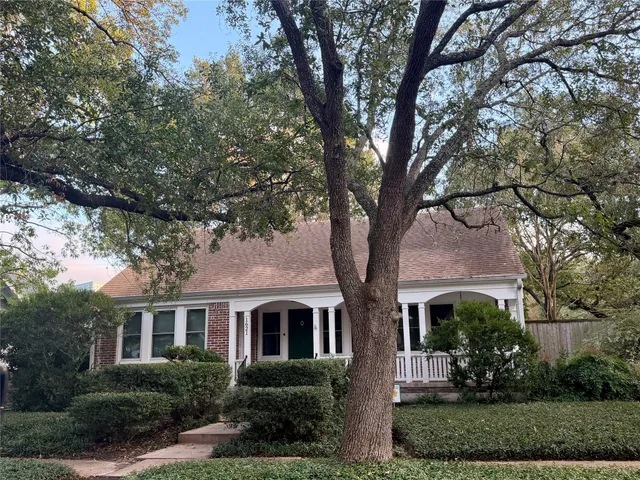 front view of a house with a tree