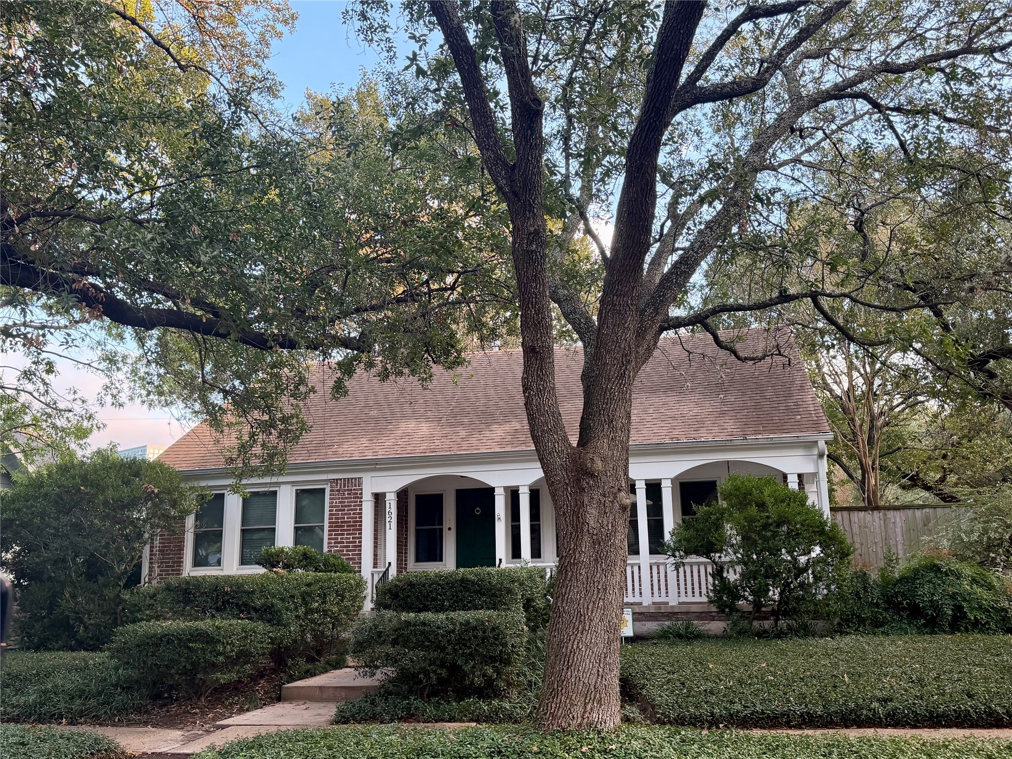 front view of a house with a tree