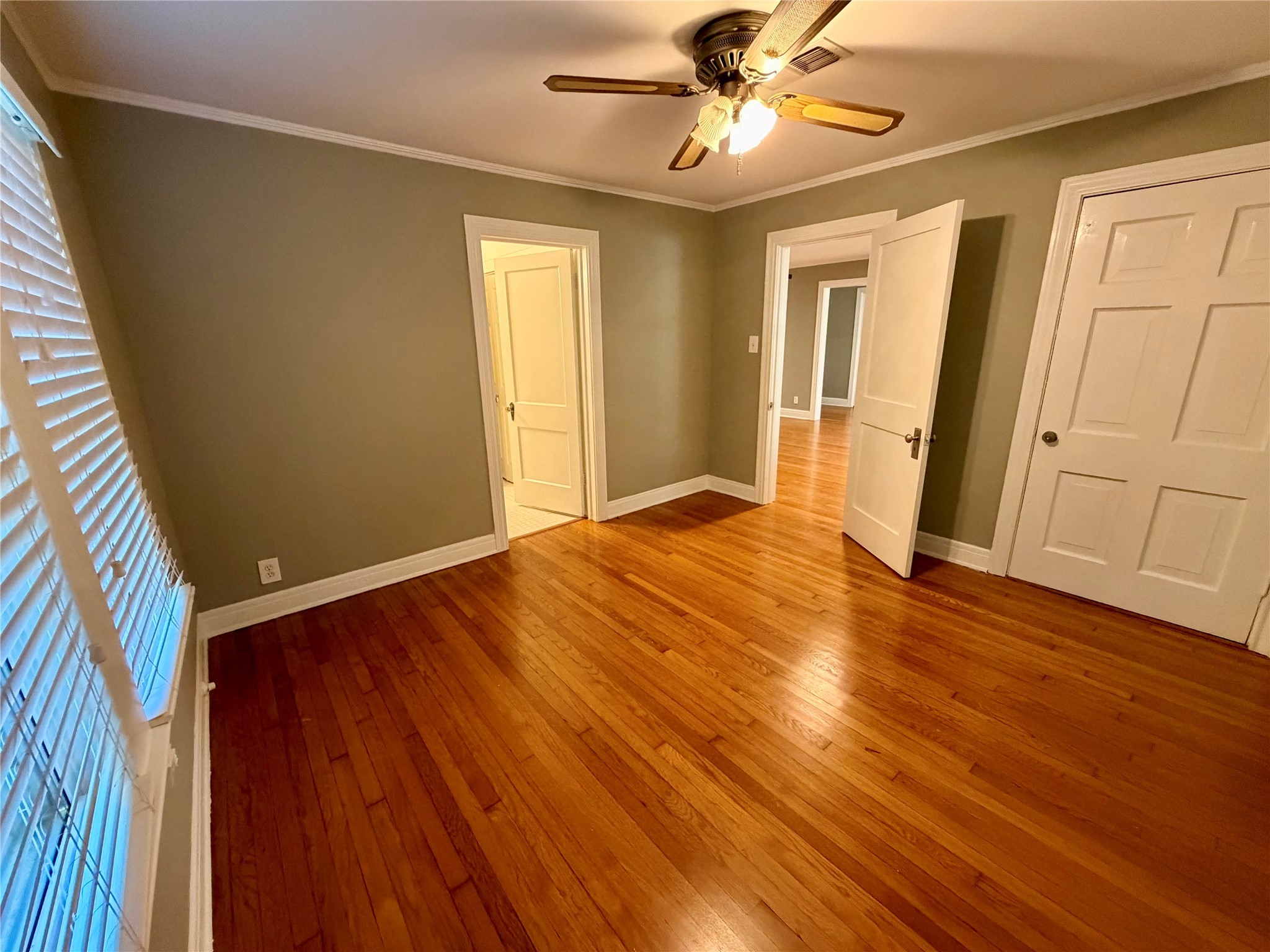 1621 Cherryhurst Street Houston, TX 77006 - Photo 11 of 21 a view of an empty room with wooden floor and a window