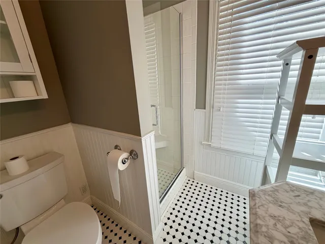a bathroom with a toilet and a shower