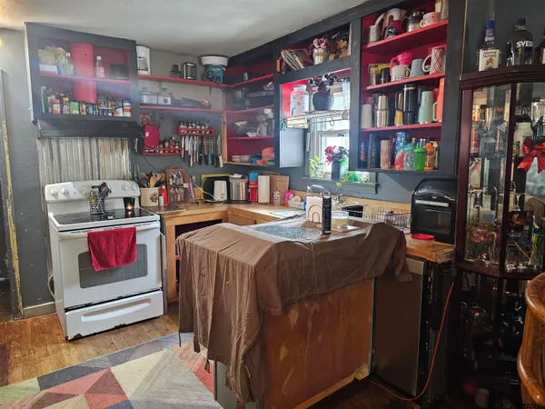 a room with lots of furniture and a book shelf