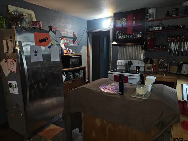 a dining room with furniture and a flat screen tv